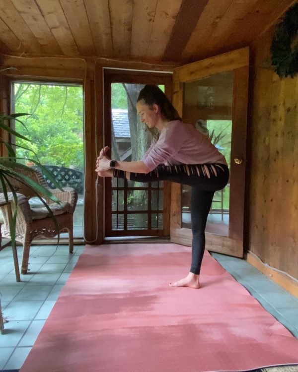 Woman Stretching on large pink yoga rug in Arizona room