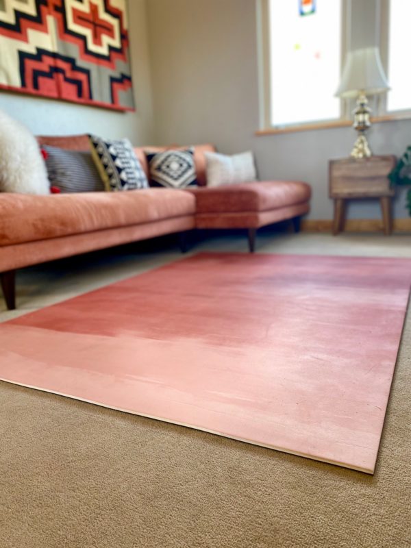 Large tan and rust yoga mat in beautiful and peaceful living room