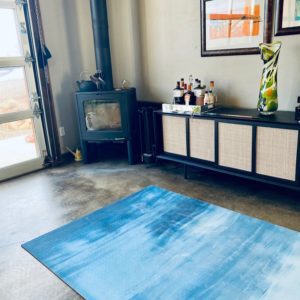 Large blue and white yoga mat in warm modern living room