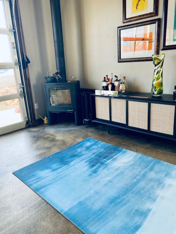 Large blue and white yoga mat in warm modern living room