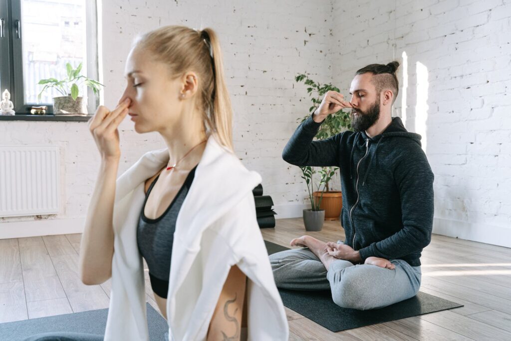 A Man and a Woman Doing Pranayama Yoga